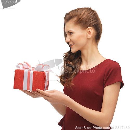 Image of teenage girl in red dress with gift box