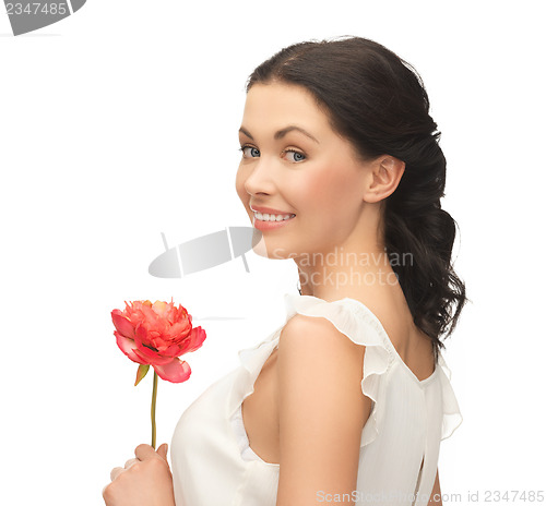 Image of young and beautiful woman with flower