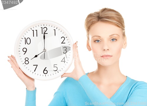 Image of businesswoman with wall clock