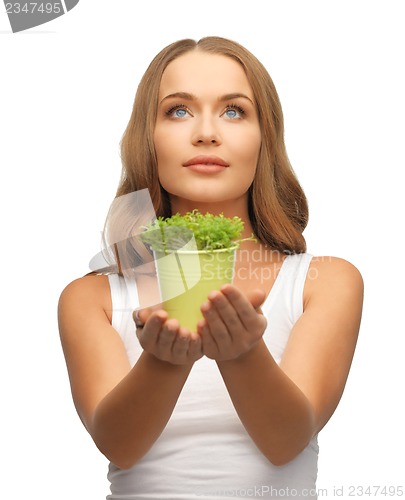 Image of woman with green grass in pot