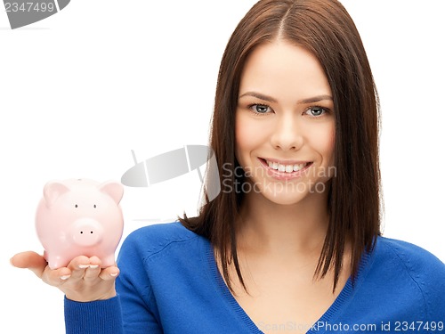 Image of lovely woman with piggy bank