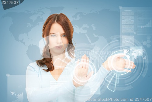 Image of businesswoman touching virtual screen