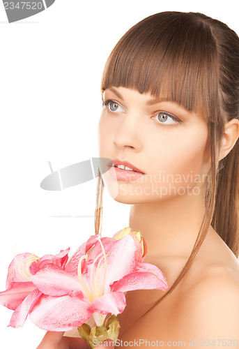 Image of lovely woman with red lily flower