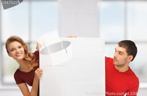 Image of man and woman with big blank board