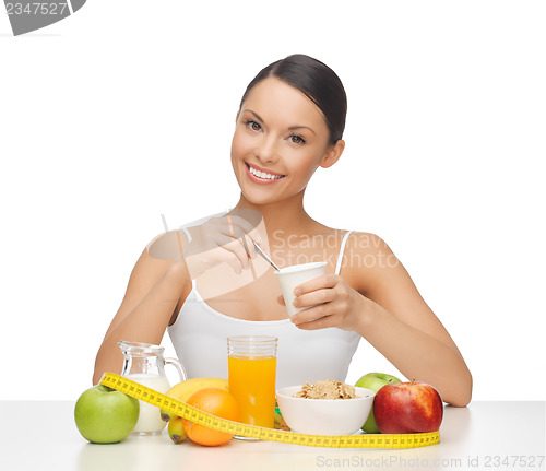 Image of woman with healthy breakfast and measuring tape