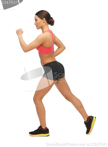Image of beautiful sporty woman doing exercise