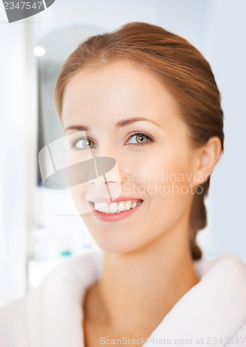 Image of beautiful woman in white bathrobe