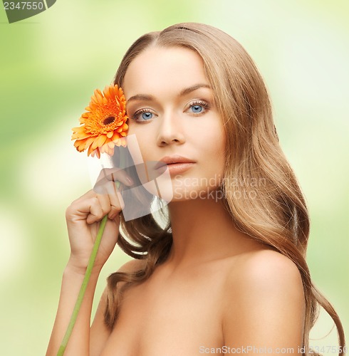 Image of lovely woman with gerbera flower