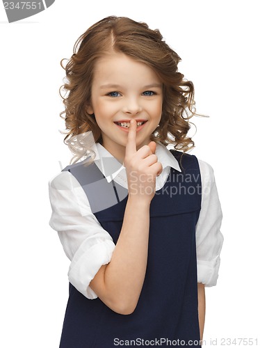 Image of pre-teen girl showing hush gesture