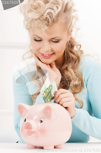 Image of woman with piggy bank and cash money