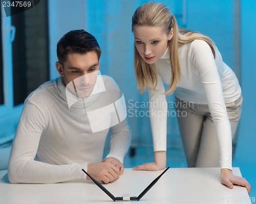 Image of man and woman working with something