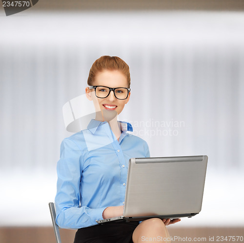Image of happy woman with laptop computer