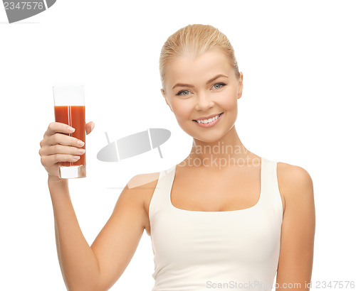 Image of woman holding glass of tomato juice