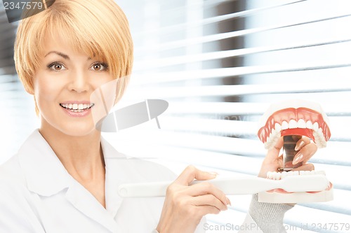 Image of doctor with toothbrush and jaws