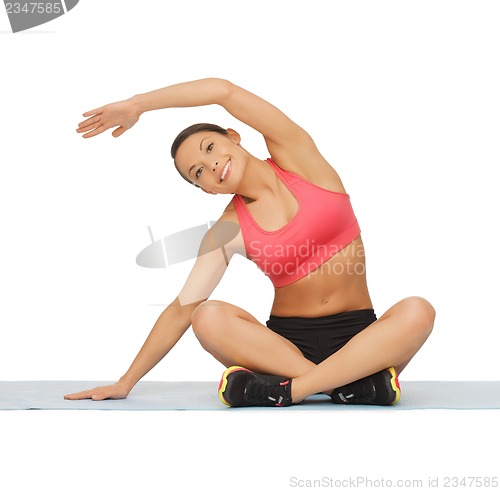 Image of beautiful sporty woman doing exercise