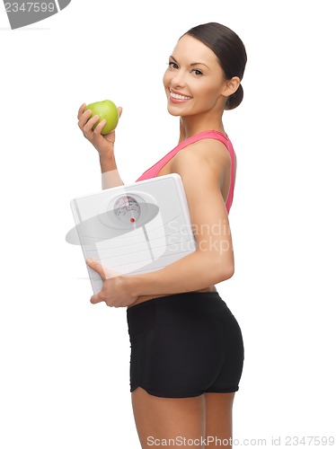 Image of woman with apple and weight scale