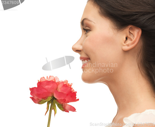 Image of smiling woman smelling flower