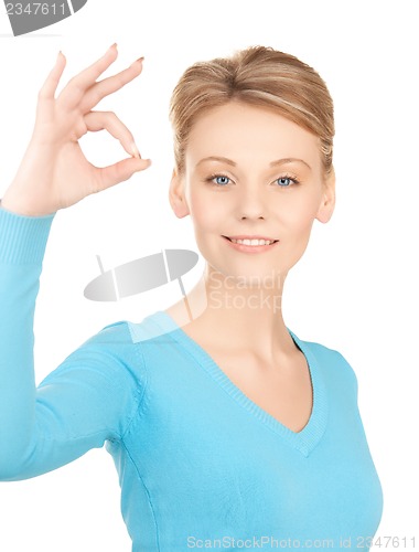 Image of young woman showing ok sign