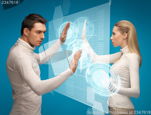 Image of man and woman working with virtual screens