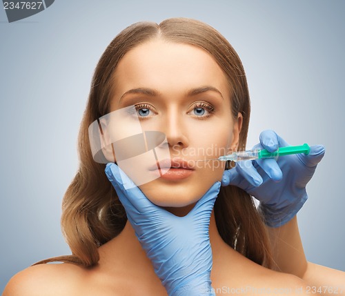 Image of woman face and beautician hands