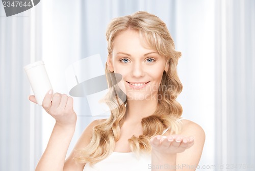 Image of young woman with pills