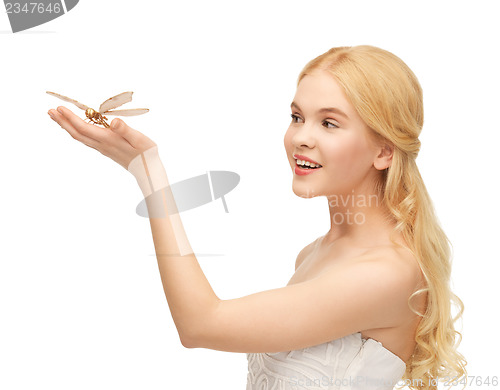 Image of woman with butterfly in hand