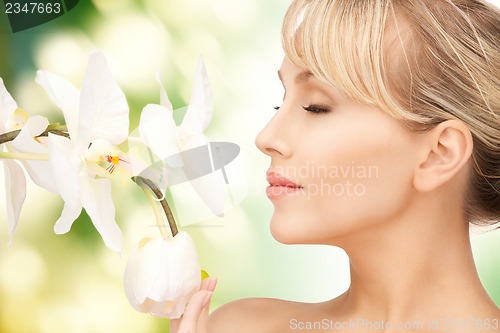 Image of beautiful woman with orchid flower