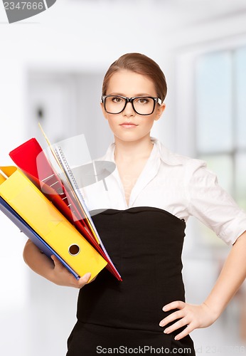 Image of young attractive businesswoman with folders