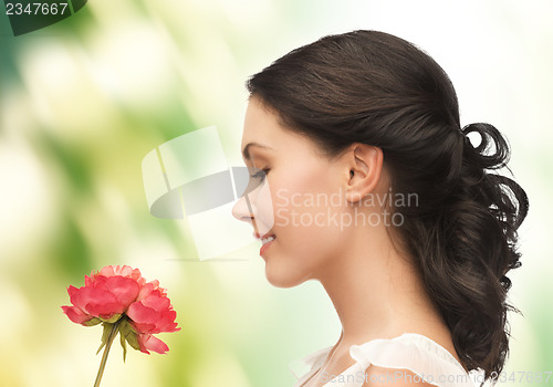 Image of young and beautiful woman with flower