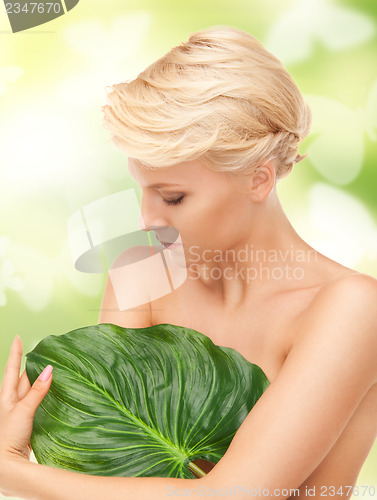 Image of woman with green leaf and butterflies