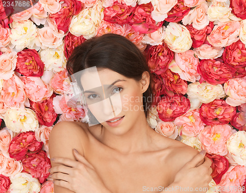 Image of beautiful woman and background full of roses