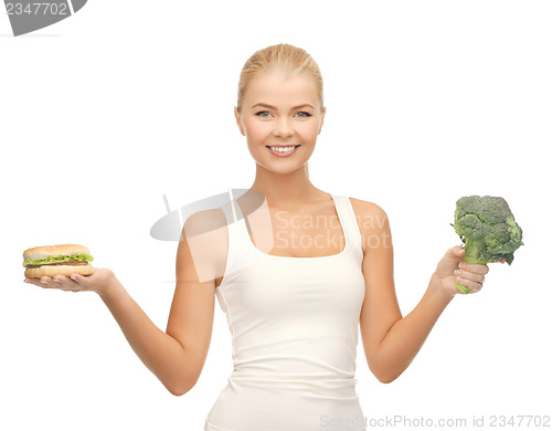 Image of woman with broccoli and hamburger