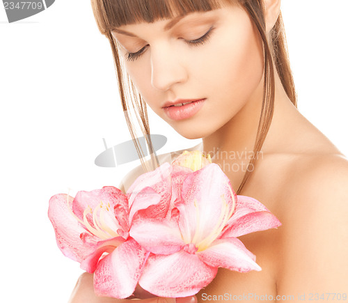 Image of lovely woman with red lily flower