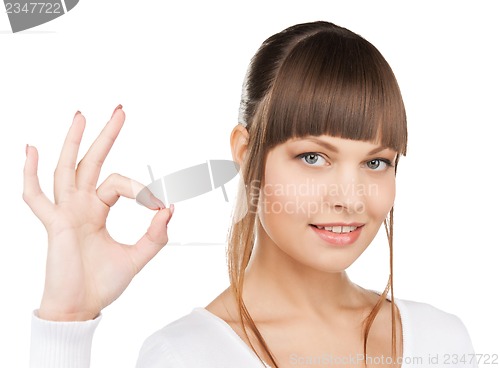 Image of young woman showing ok sign