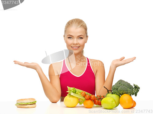 Image of woman with fruits and hamburger