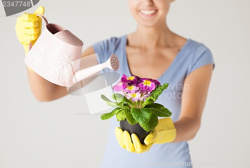 Image of woman holding pot with flower