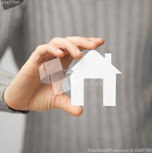 Image of man holding paper house