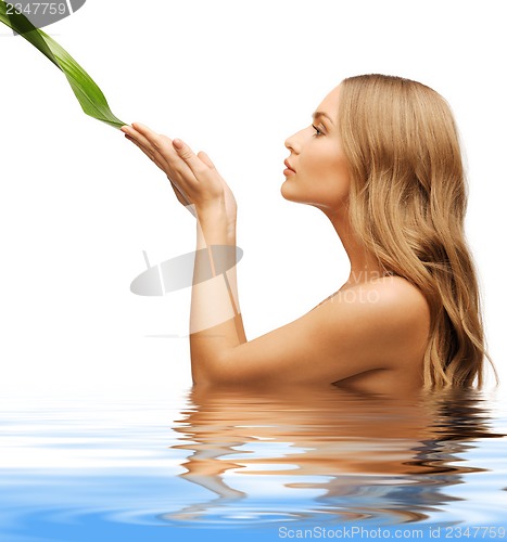 Image of woman with green leaf
