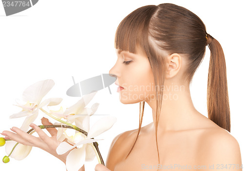 Image of lovely woman with orchid flower