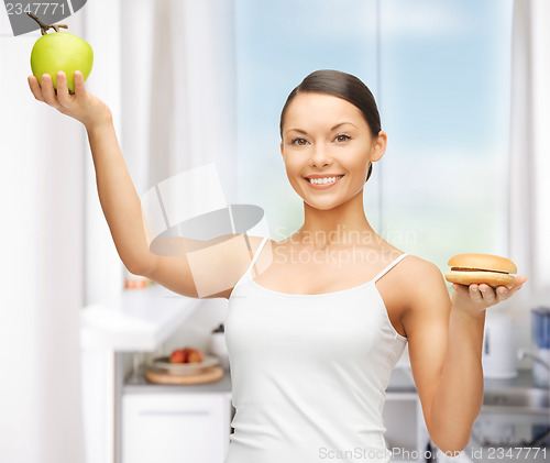 Image of woman with hamburger and apple