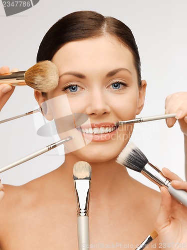 Image of beautiful woman with brushes
