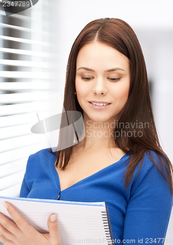 Image of happy woman with big notepad