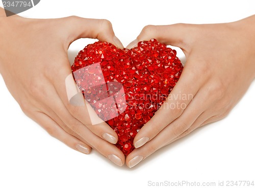 Image of woman hands holding heart