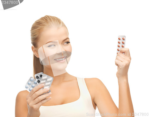 Image of young woman with pills