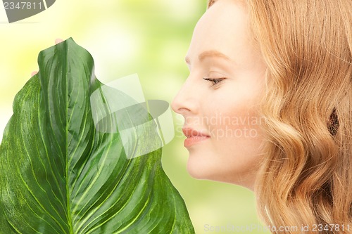 Image of woman with green leaf