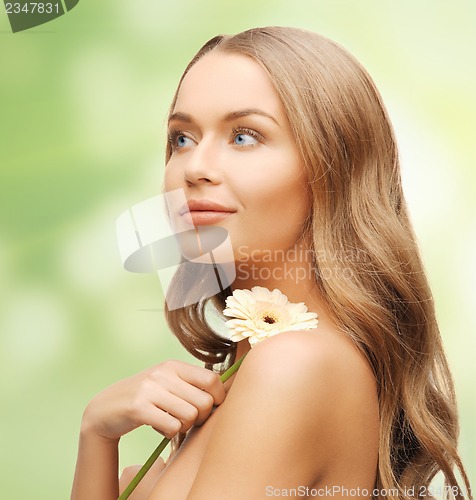 Image of lovely woman with gerbera flower