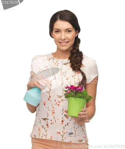 Image of woman holding pot with flower and spray bottle