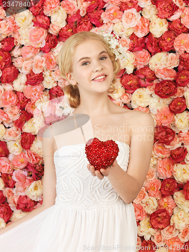 Image of woman with heart and background full of roses