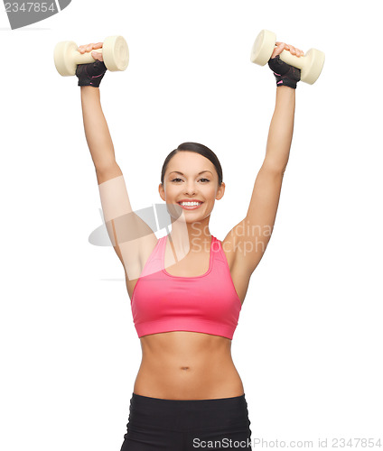 Image of young sporty woman with light dumbbells