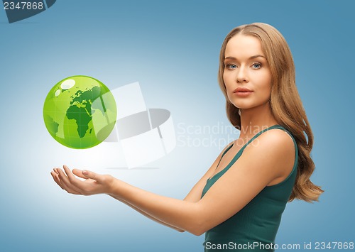 Image of woman holding green globe on her hands